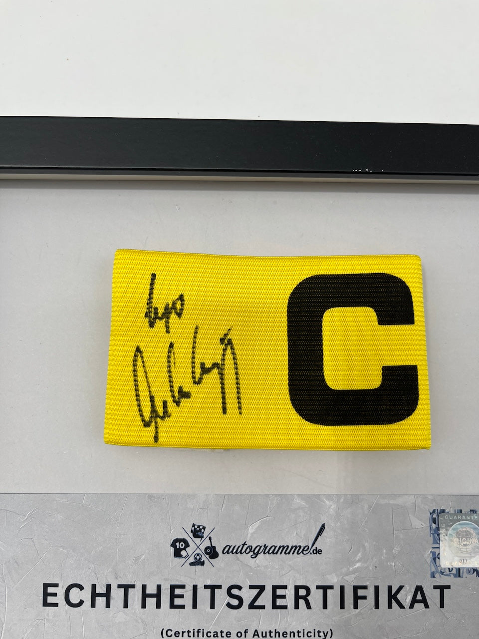 Captain's armband signed by Ingo Anderbrügge in a Schalke 04 COA frame