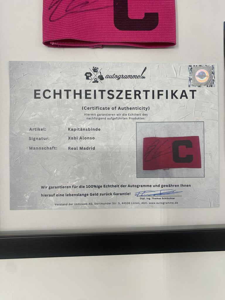 Captain's armband signed by Xabi Alonso in a Real Madrid football COA autograph frame