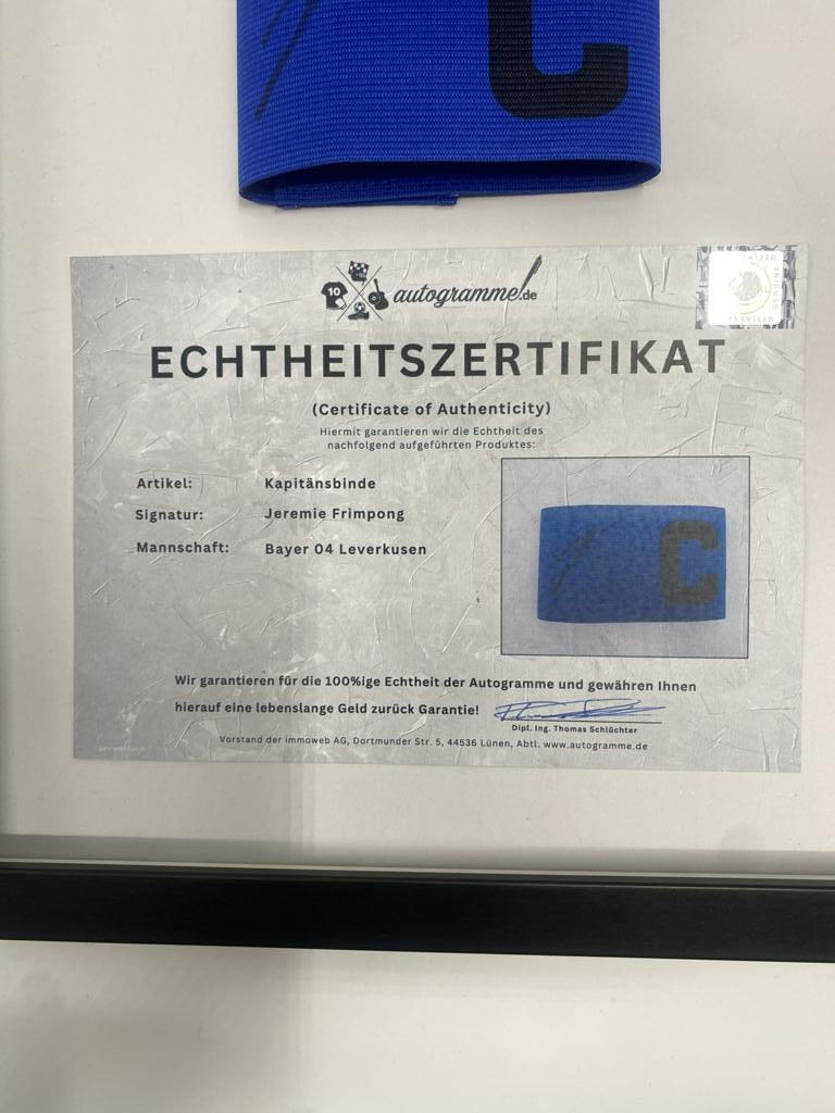 Captain's armband signed by Jeremie Frimpong in a frame, Bayer 04 Leverkusen autograph