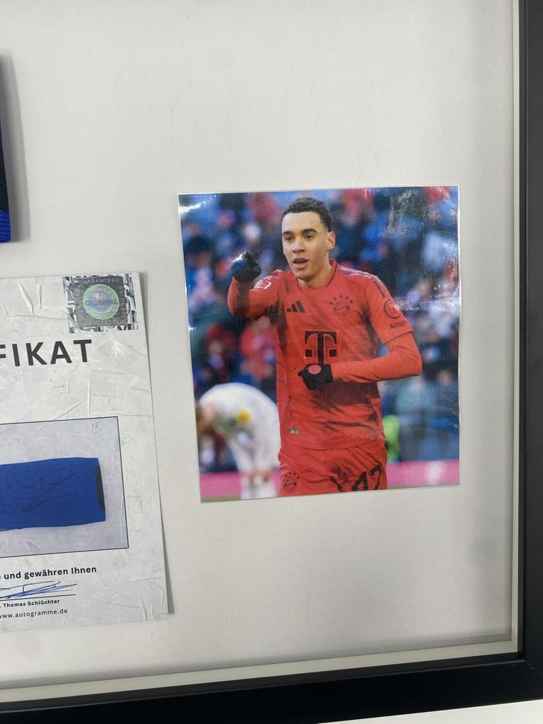 Captain's armband signed by Jamal Musiala in a Bayern Munich football autograph frame