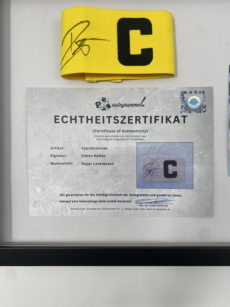 Captain's armband signed by Simon Rolfes in a frame, autographed by Bayer 04 Leverkusen