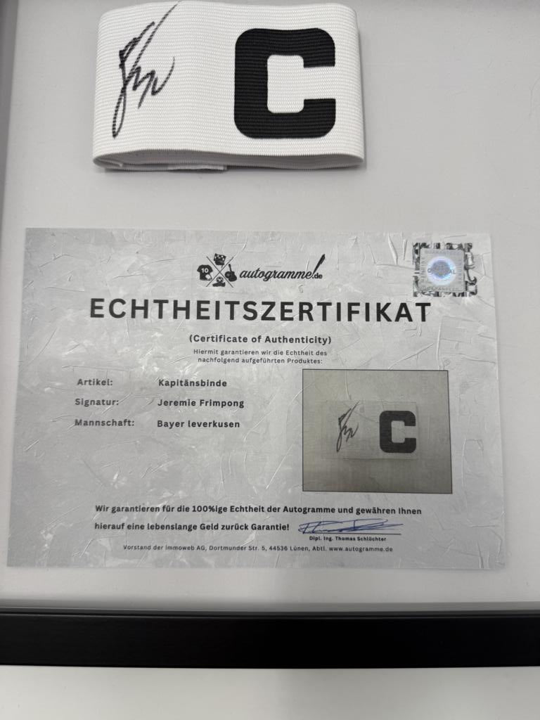 Captain's armband signed by Jeremie Frimpong in a frame, Bayer 04 Leverkusen autograph