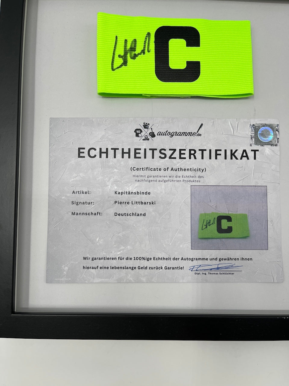 Captain's armband signed by Pierre Littbarski in a DFB autograph COA frame