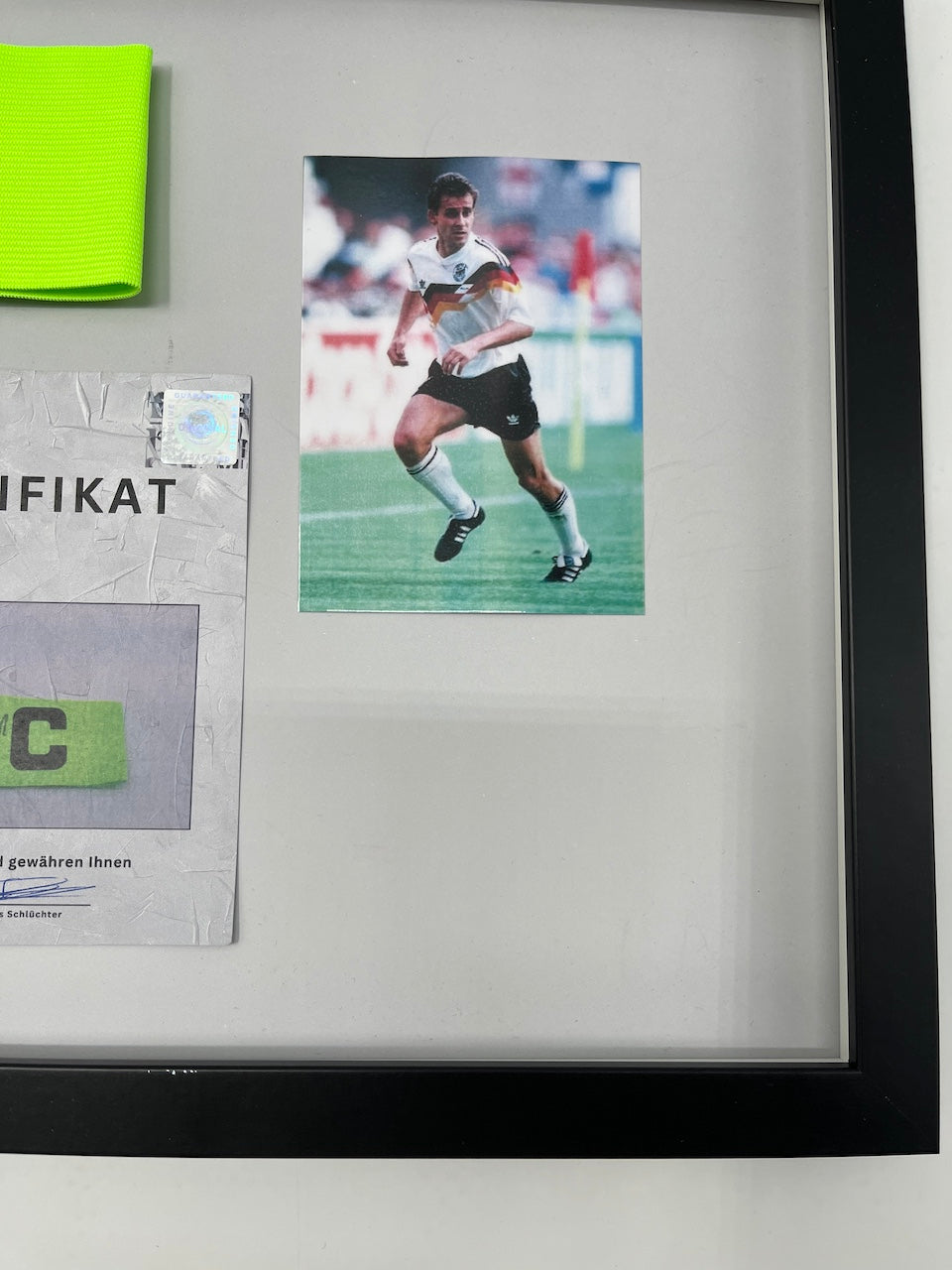 Captain's armband signed by Pierre Littbarski in a DFB autograph COA frame