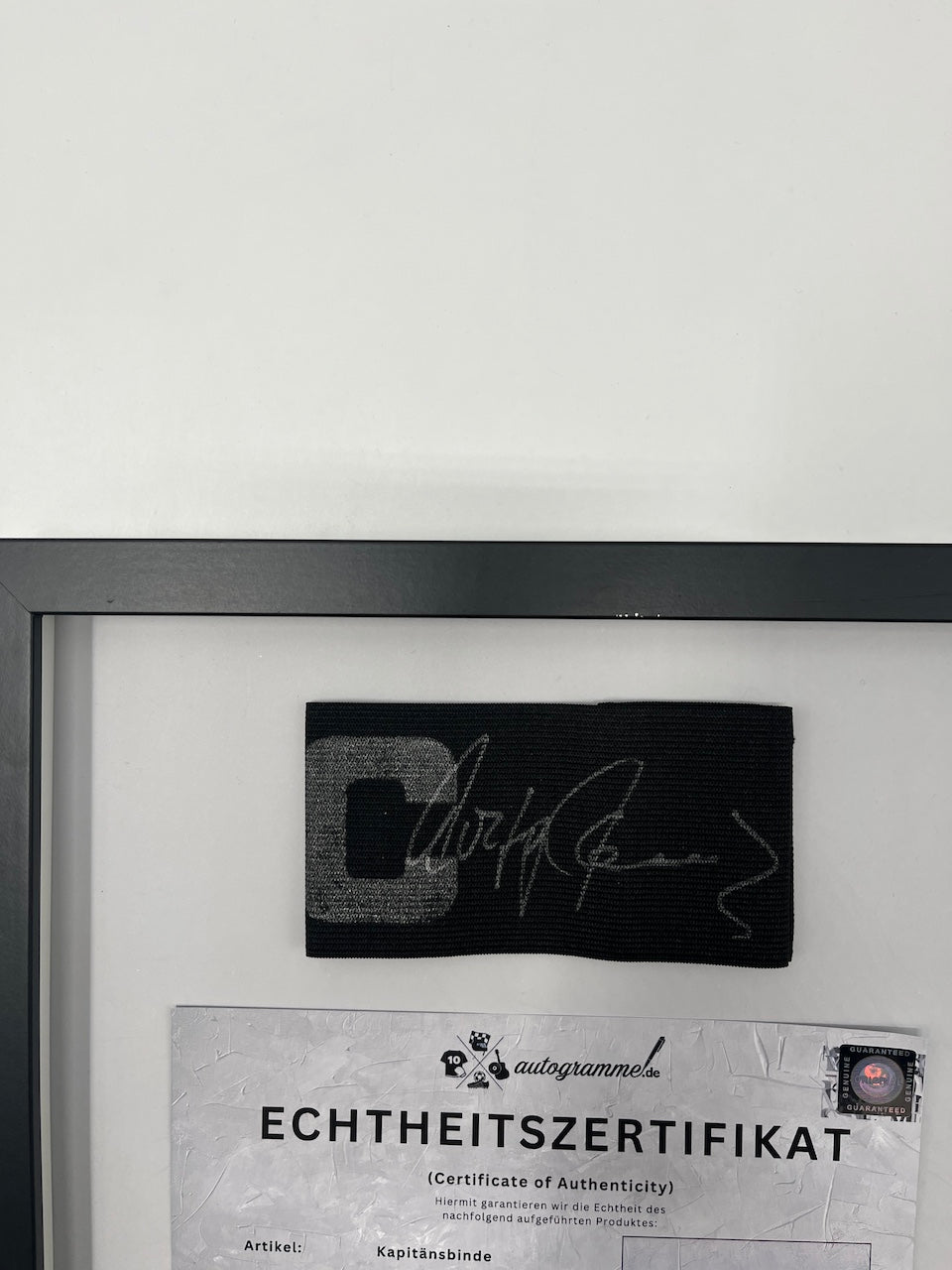 Captain's armband signed by Wolfgang Overath in a frame, Cologne Autograph