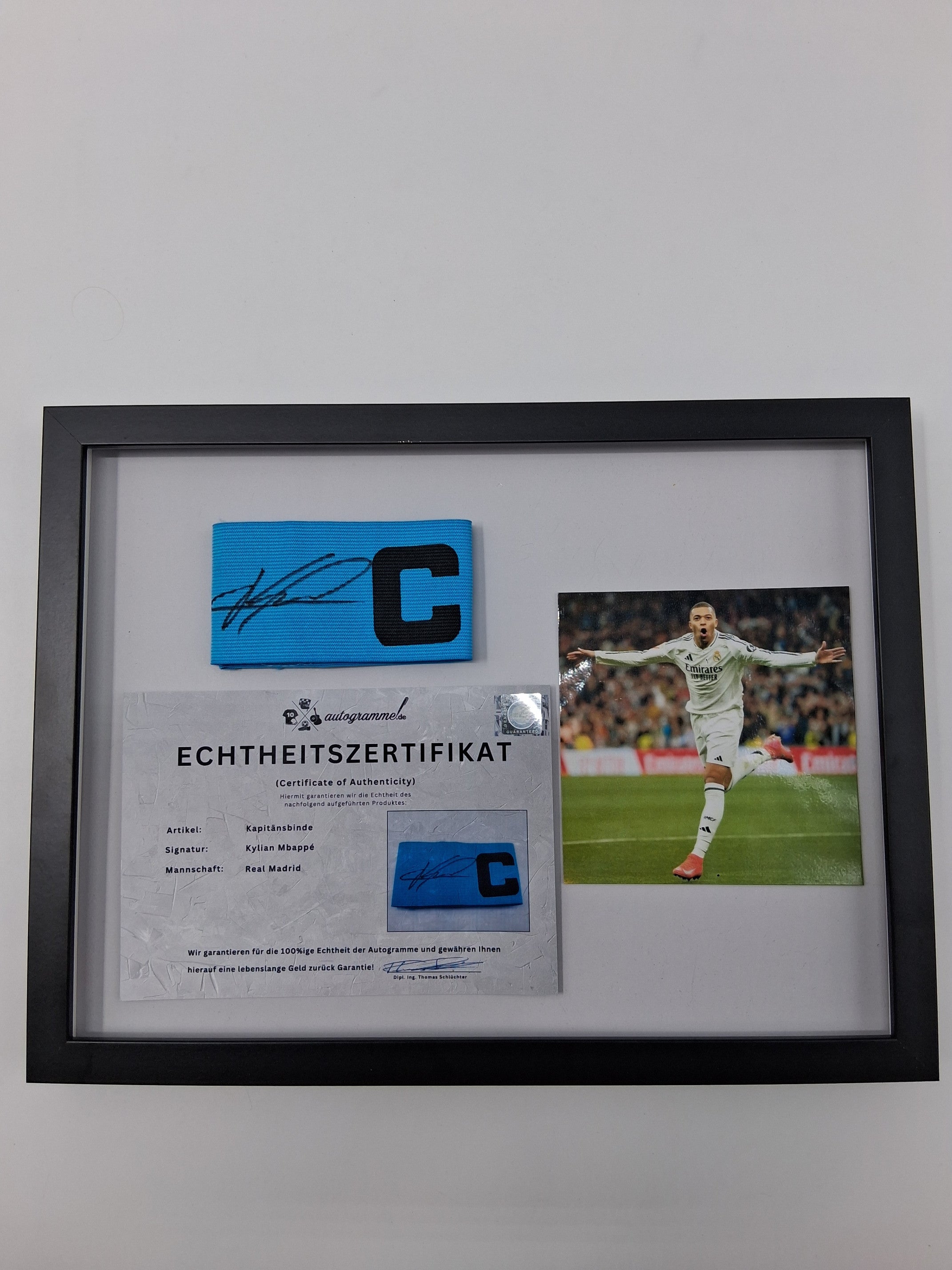 Captain's armband signed by Kylian Mbappe in a Real Madrid COA autograph frame