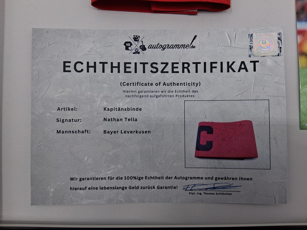Captain's armband signed by Nathan Tella in a Bayer Leverkusen autograph frame