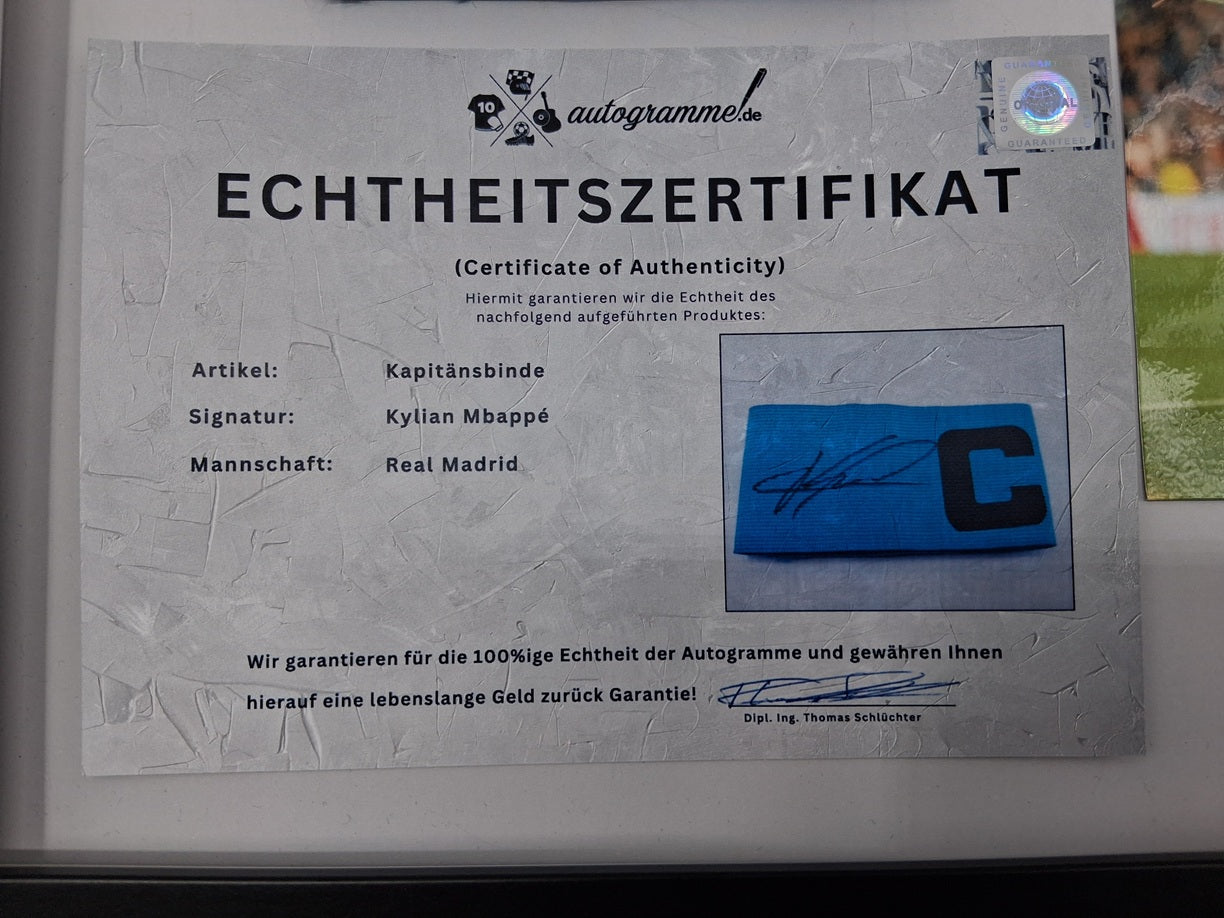 Captain's armband signed by Kylian Mbappe in a Real Madrid COA autograph frame