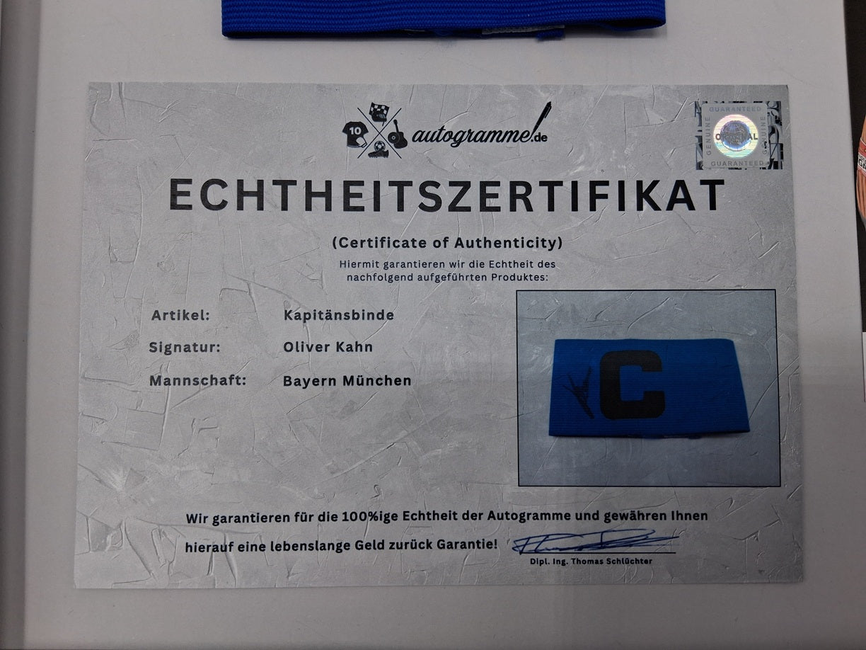 Captain's armband signed by Oliver Kahn in a Bayern Munich football autograph frame
