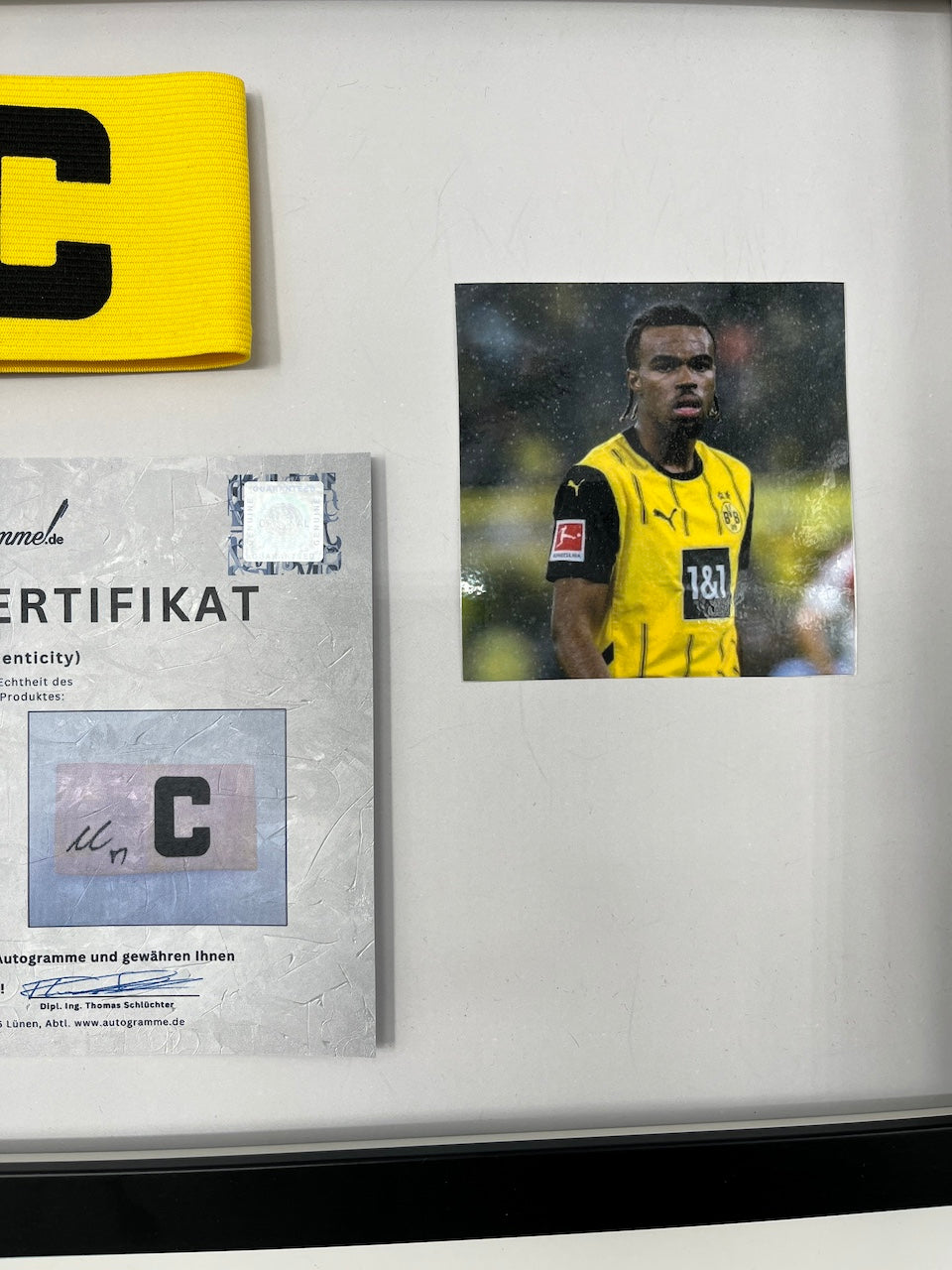 Captain's armband signed by Carney Chukwuemeka in a Borussia Dortmund COA frame