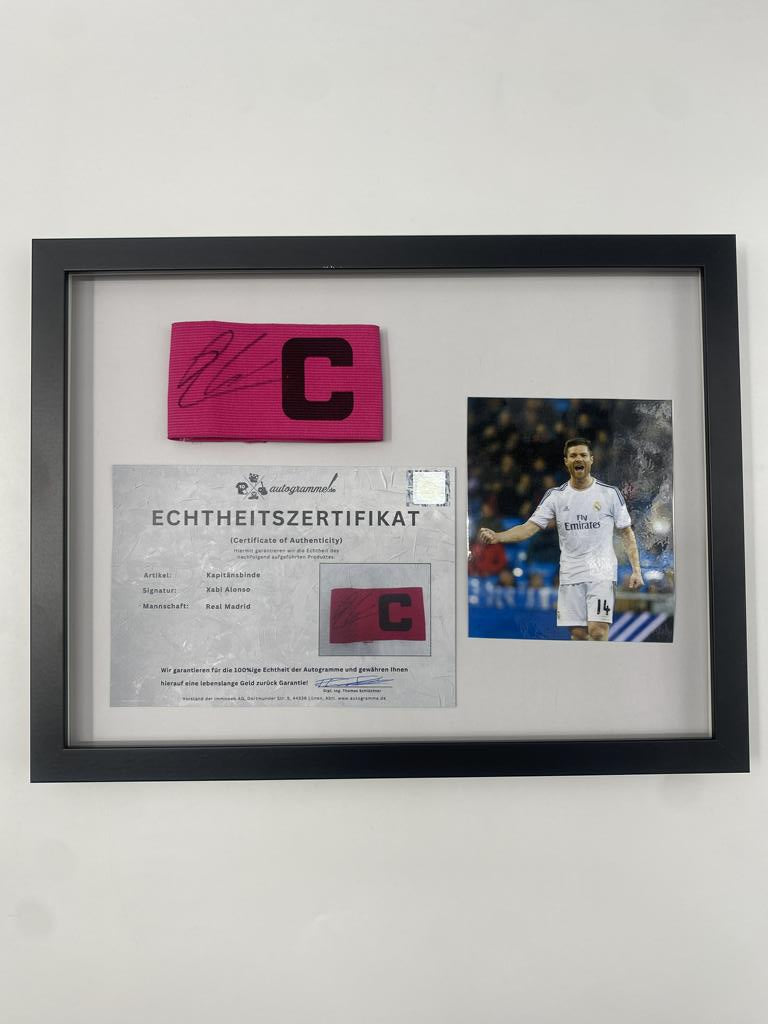 Captain's armband signed by Xabi Alonso in a Real Madrid football COA autograph frame