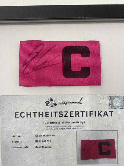 Captain's armband signed by Xabi Alonso in a Real Madrid football COA autograph frame