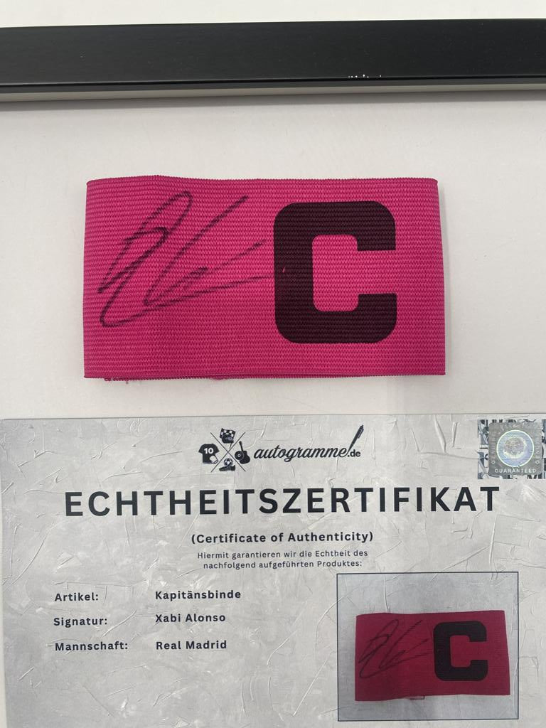 Captain's armband signed by Xabi Alonso in a Real Madrid football COA autograph frame