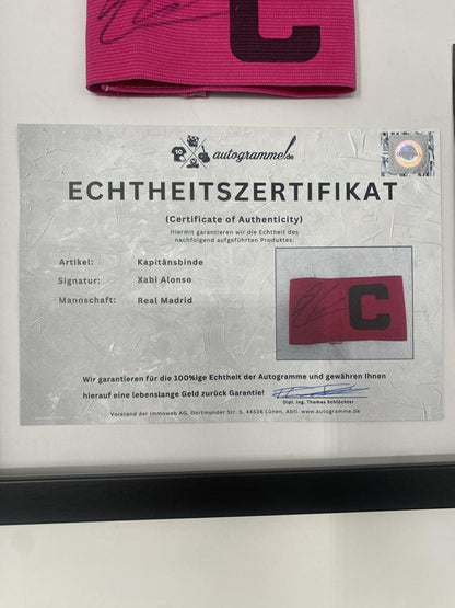 Captain's armband signed by Xabi Alonso in a Real Madrid football COA autograph frame