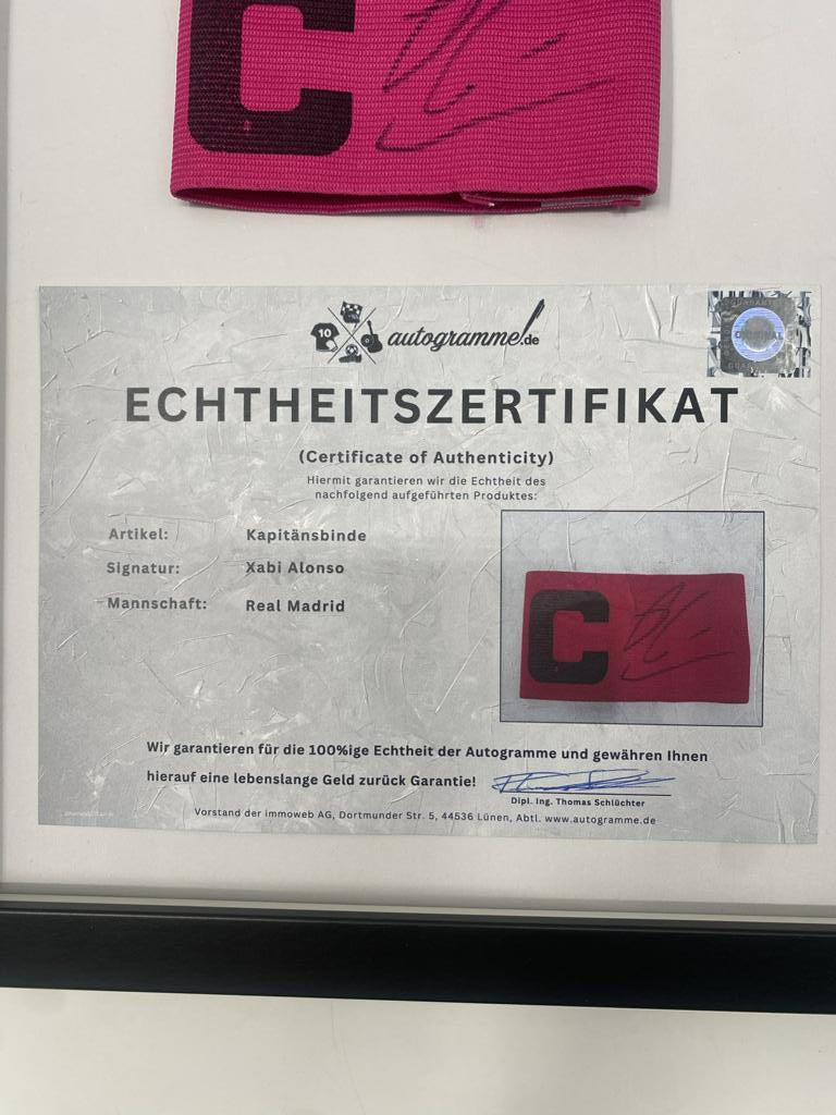 Captain's armband signed by Xabi Alonso in a Real Madrid football COA autograph frame