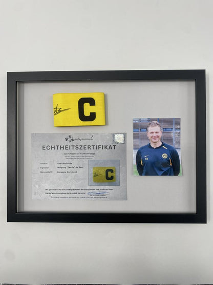 Captain's armband signed by Wolfgang "Teddy" de Beer in a Borussia Dortmund COA frame