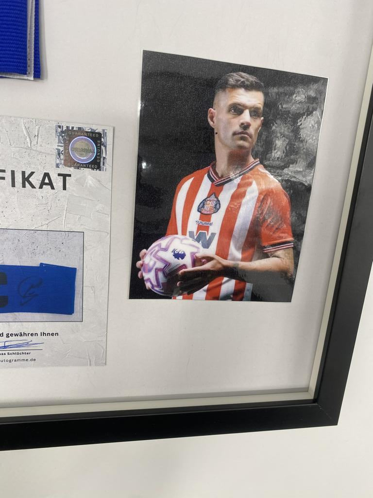 Captain's armband signed by Granit Xhaka in a frame, AFC Sunderland autograph