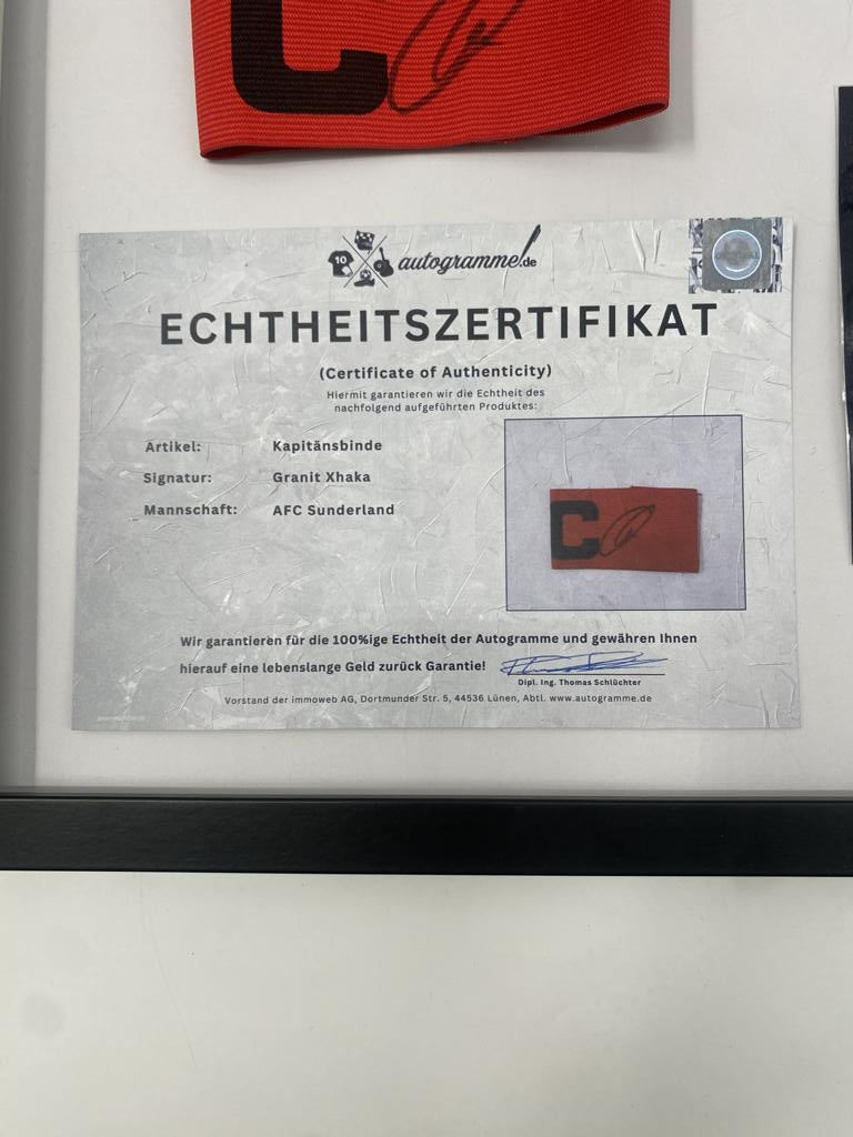 Captain's armband signed by Granit Xhaka in a frame, AFC Sunderland football autograph