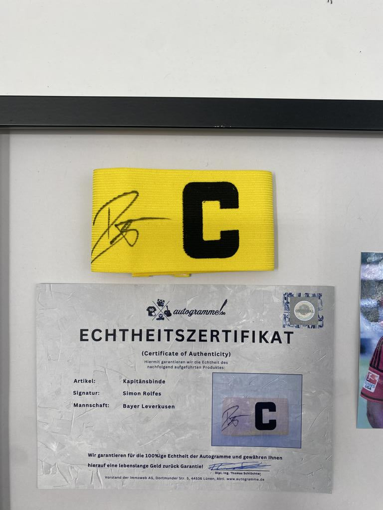 Captain's armband signed by Simon Rolfes in a frame, autographed by Bayer 04 Leverkusen