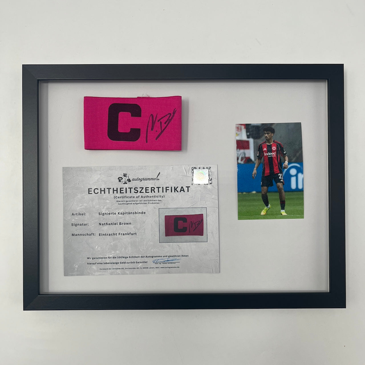 Kapitänsbinde Nathaniel Brown signiert im Rahmen Eintracht Frankfurt pink