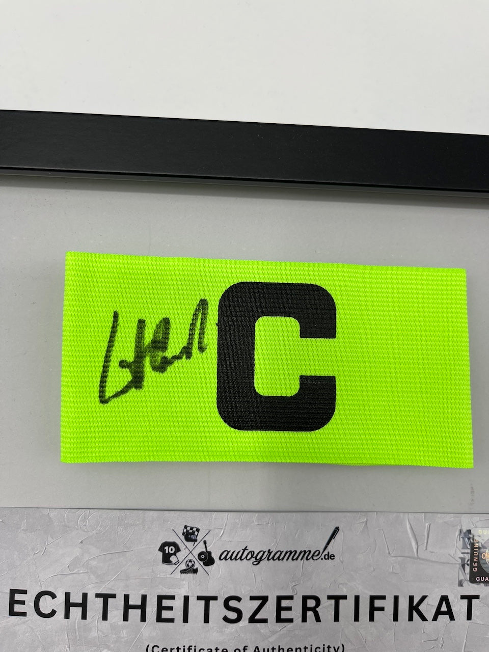 Captain's armband signed by Pierre Littbarski in a DFB autograph COA frame